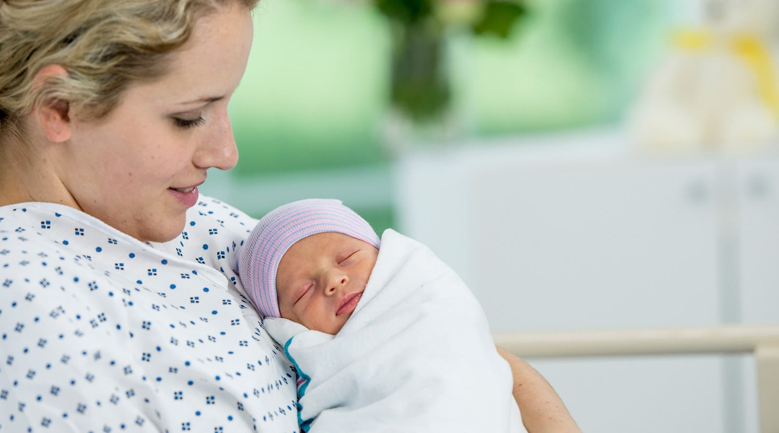 Mother holding her newborn baby after having given birth