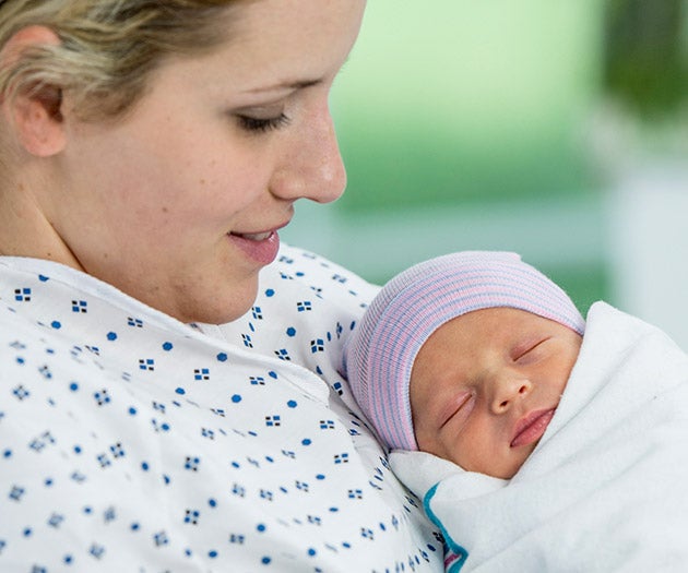 Mother holding her newborn baby after having given birth