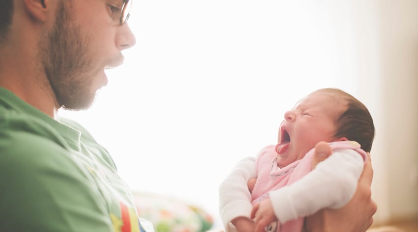 baby-crying-body_850-1.jpg parent carrying their crying baby
