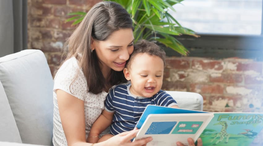 Mum encouraging baby to talk and read with a book Mum encouraging baby to talk and read with a book