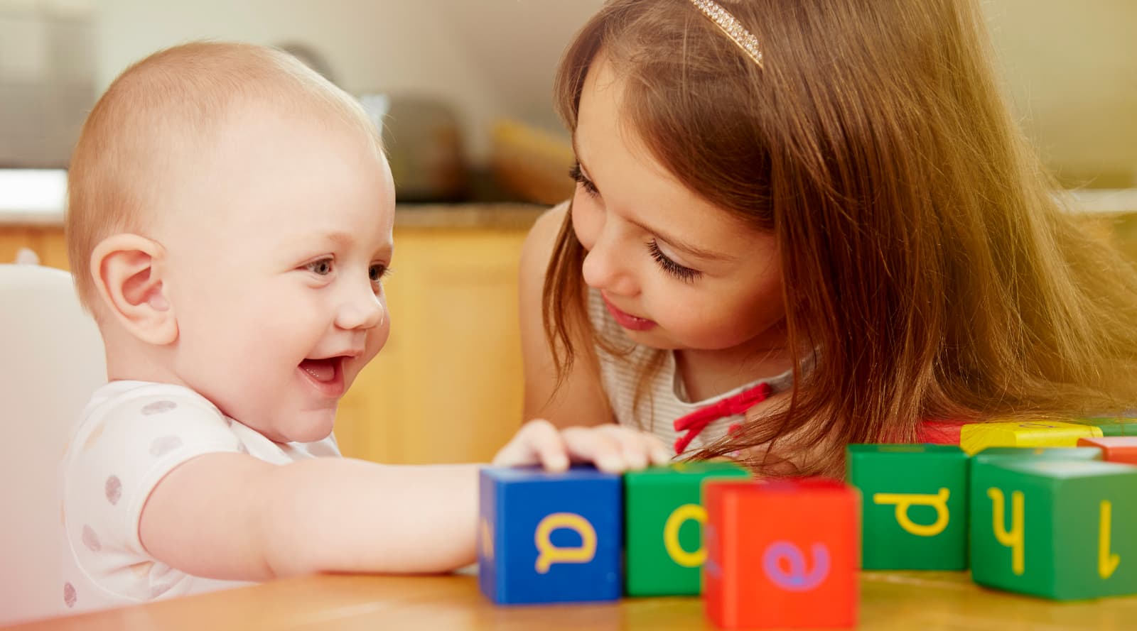 Child playing an interactive game with a toddler