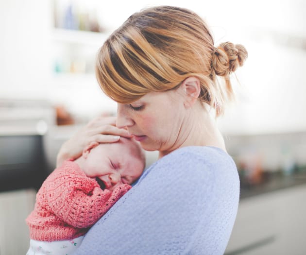 mother carrying her crying baby