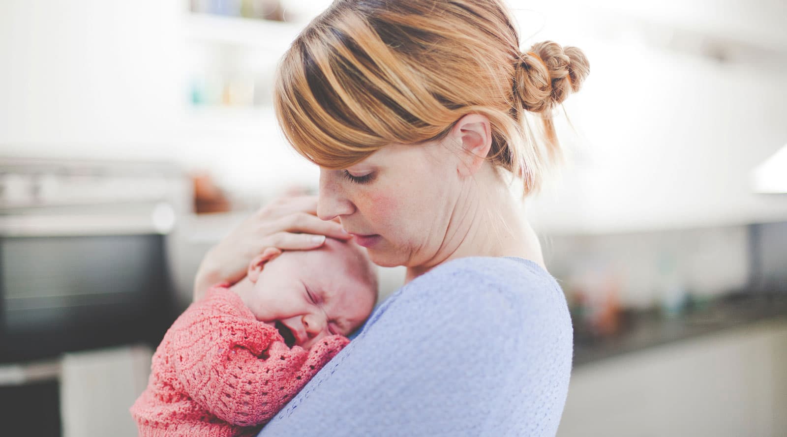 mother carrying her crying baby