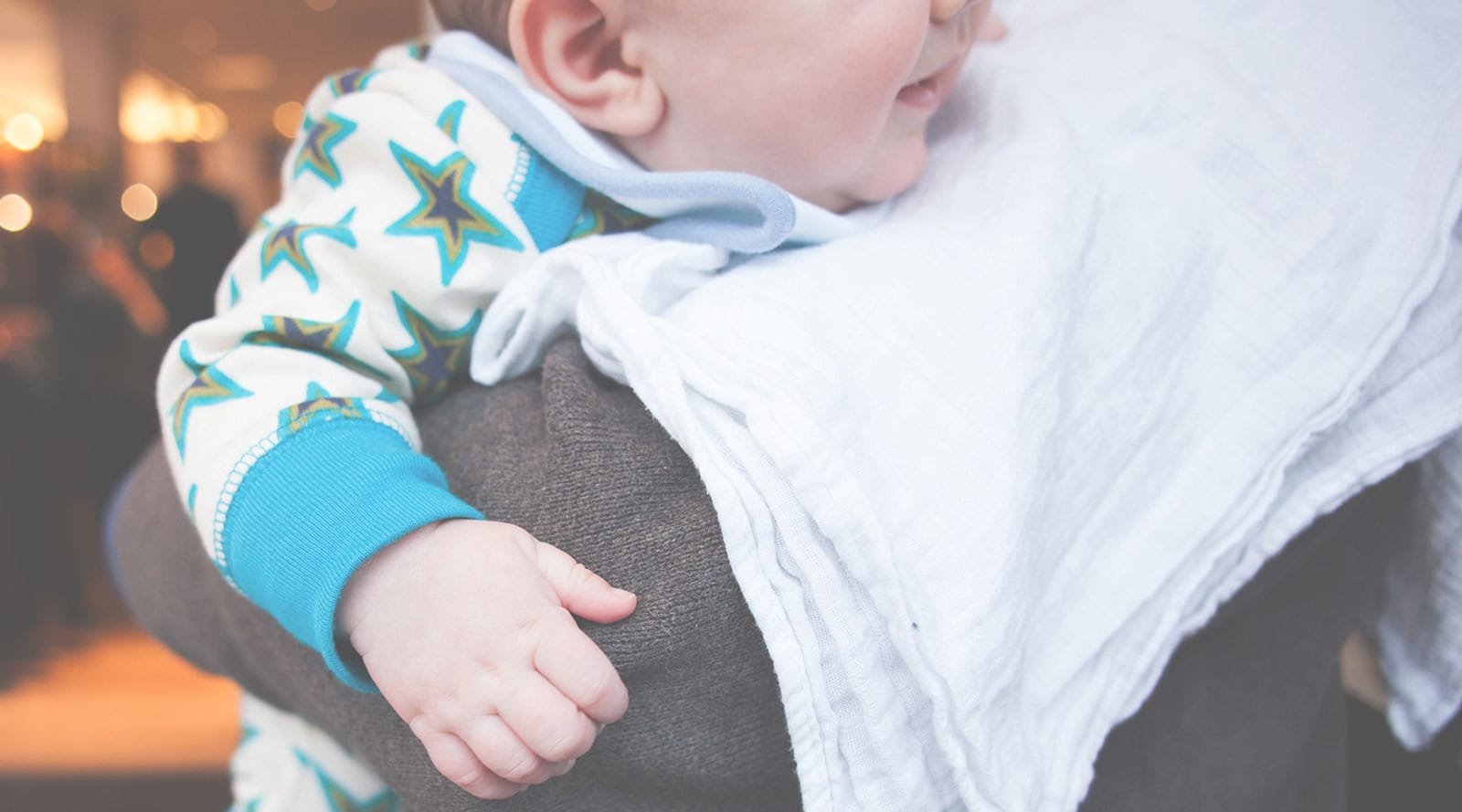 mother burping her newborn baby