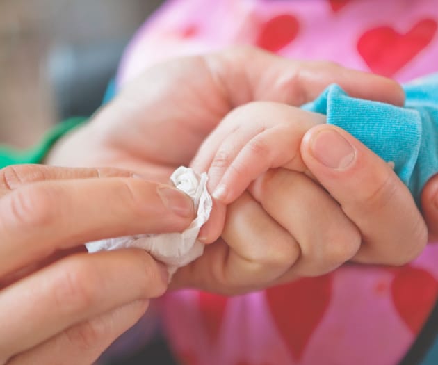 baby getting hands cleaned