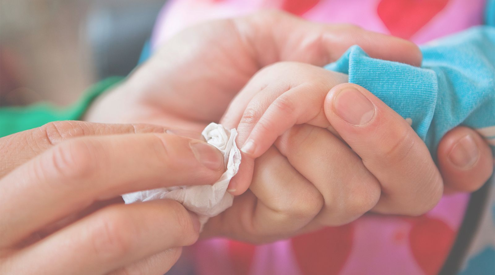 baby getting hands cleaned
