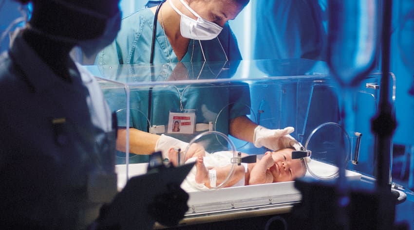 newborn-what-happens-after-you-have-premature-baby-body_850-1.jpg A doctor examining a premature baby in neonatal care