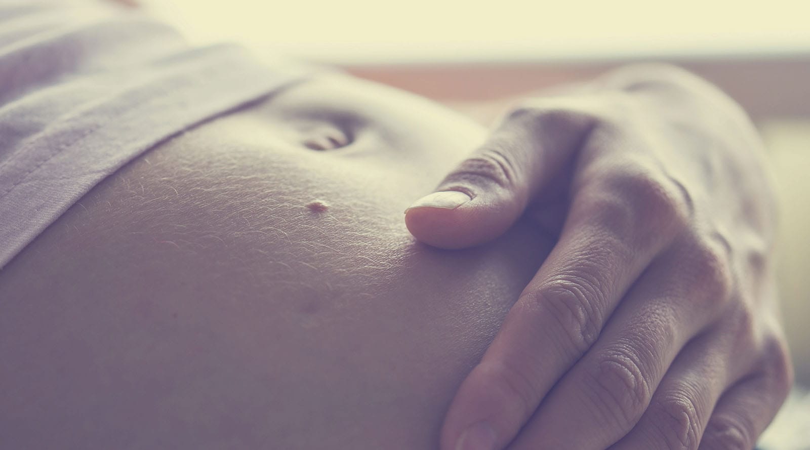 mother holding her baby bump