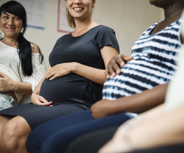 pregnant mothers sitting at an antenatal class