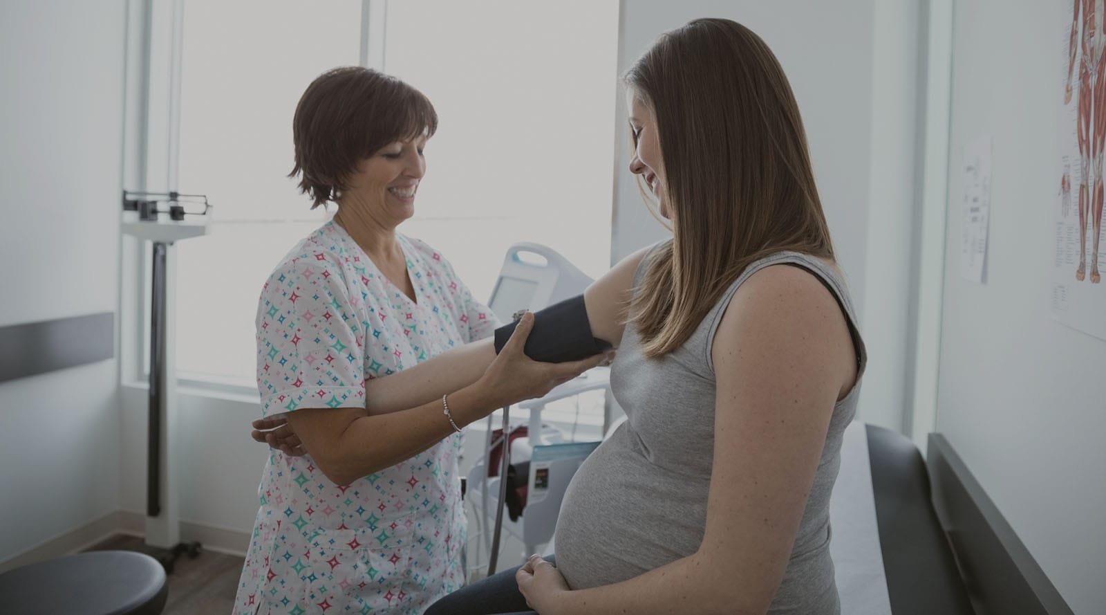 Midwife taking pregnant mother’s blood pressure